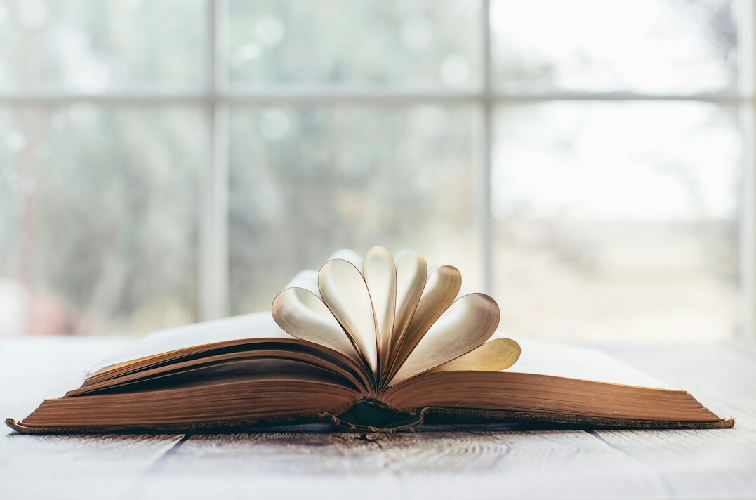 Stack of old books on a wooden table