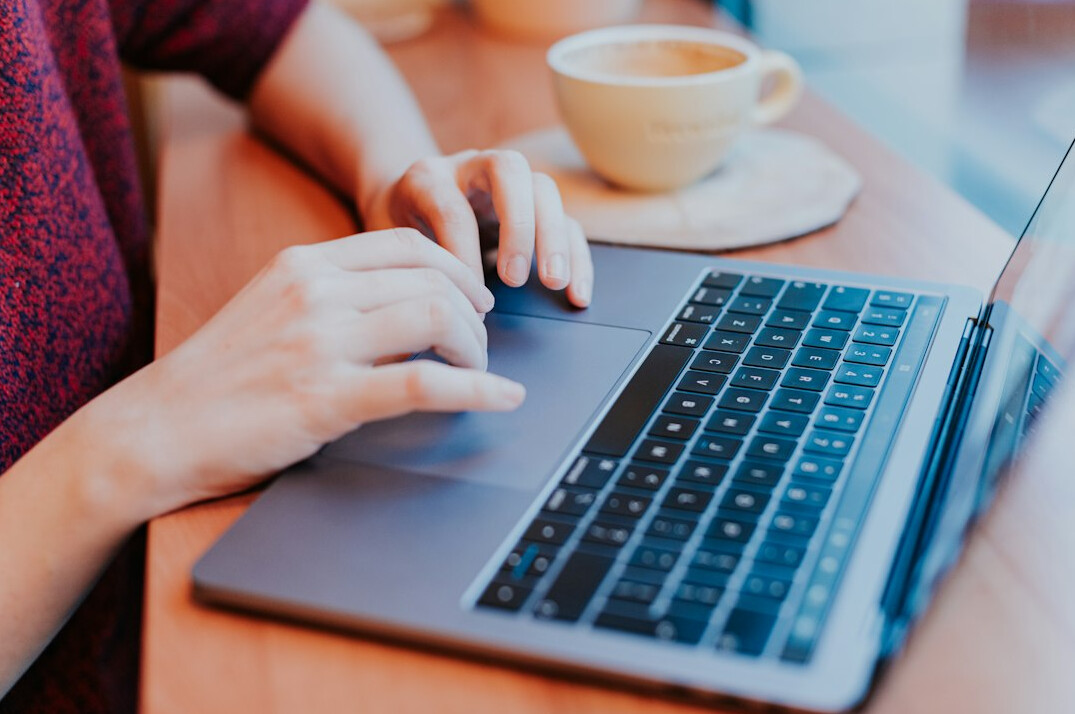 writer typing on laptop